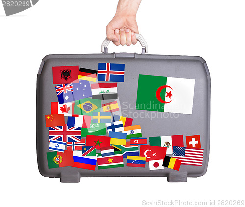 Image of Used plastic suitcase with stickers