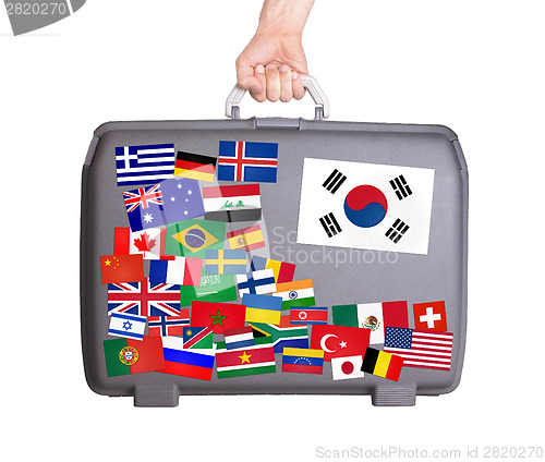 Image of Used plastic suitcase with stickers