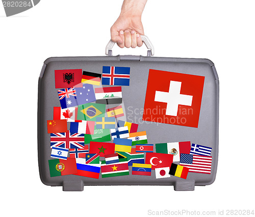 Image of Used plastic suitcase with stickers