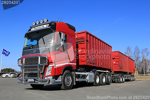 Image of Red Volvo FH Truck with Full Trailer and Blue Sky