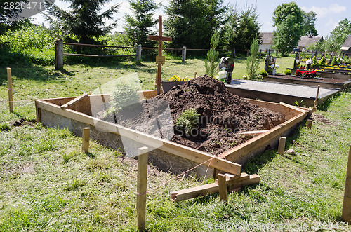 Image of fresh grave soil and foundation in cemetery 