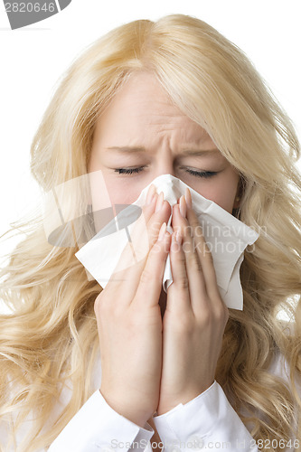 Image of Ill woman with tissue is sneezing