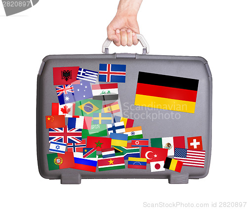 Image of Used plastic suitcase with stickers