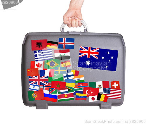 Image of Used plastic suitcase with stickers
