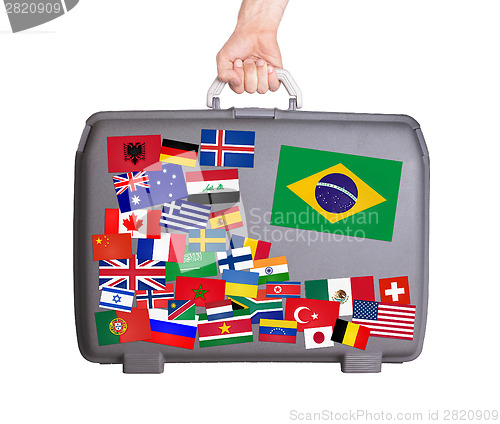 Image of Used plastic suitcase with stickers