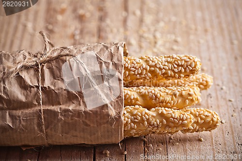 Image of bread sticks grissini with sesame seeds in craft pack