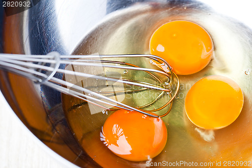 Image of whisking eggs in metal bowl 