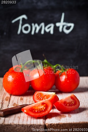 Image of fresh tomatoes, knife and blackboard 
