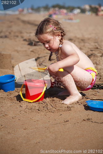 Image of Kid playing with sand