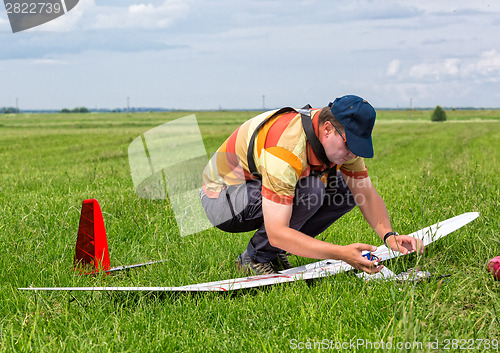 Image of Man makes the assembly RC glider