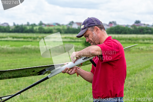 Image of Man makes the assembly RC glider