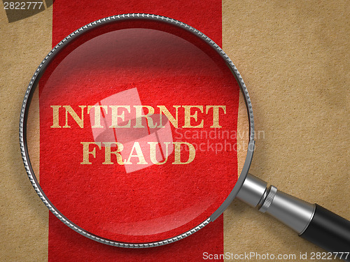 Image of Internet Fraud. Magnifying Glass on Old Paper.