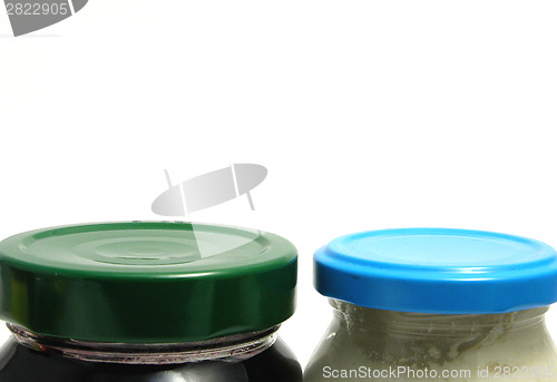 Image of A green and a blue screw lid on glasses
