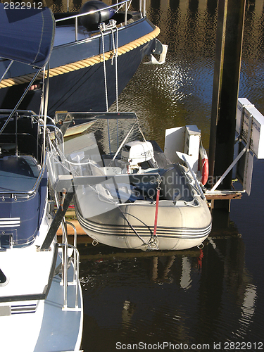 Image of One boat with dinghy in the harbour