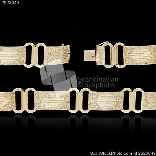 Image of Gold bracelet on black background