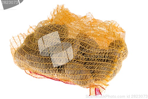 Image of Ripe potatoes in burlap sack isolated on white background