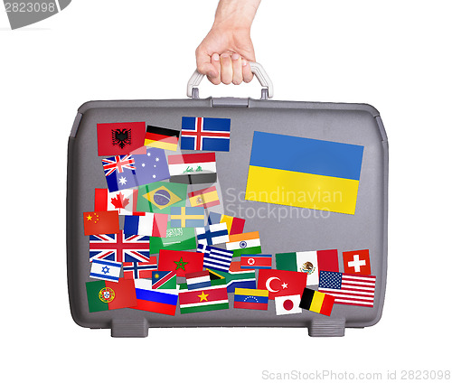 Image of Used plastic suitcase with stickers