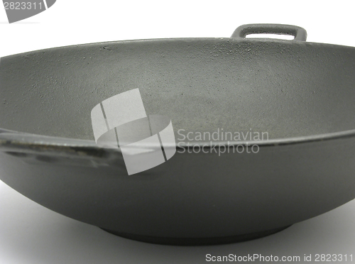 Image of A big black wok for cooking on white