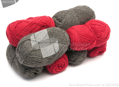 Image of Gray and red new wool lying upon another on white background