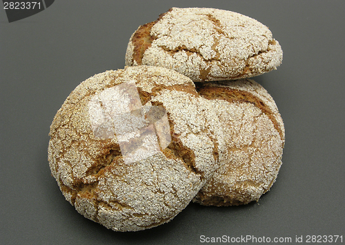 Image of Home made wholemeal vinschgauer buns on black underlay