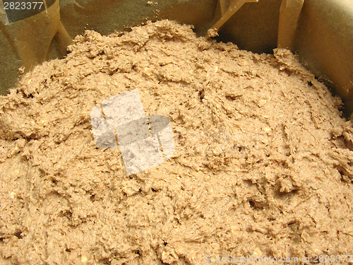 Image of Mixed unbaken chocolate dough in a baking pan with baking paper