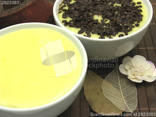 Image of Custards with and without grated chocolate in bowls of china war