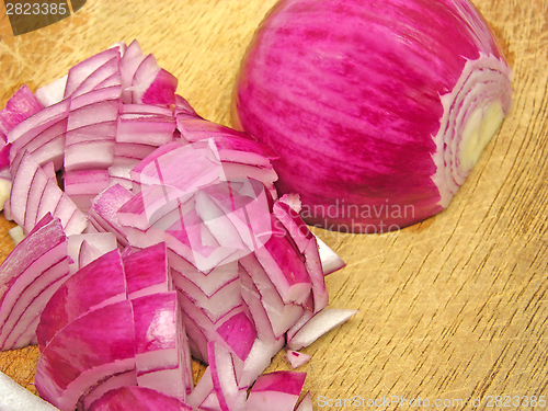 Image of Diced red onion on a brown wooden plate