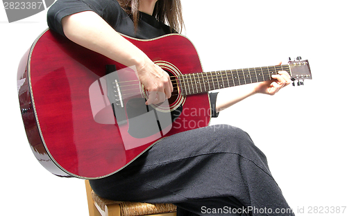 Image of Cutout woman with guitar sitting on a chair