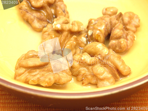 Image of Walnut oil with walnuts in a bowl of ceramic in a close-up view