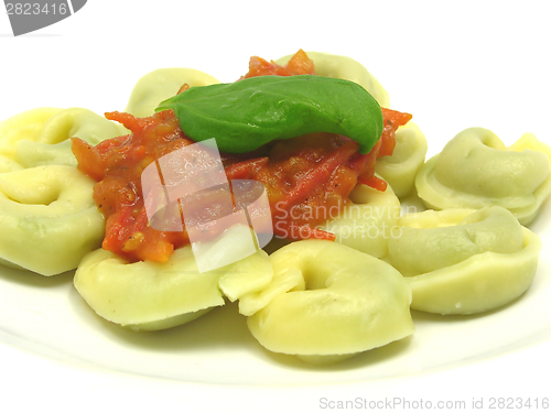 Image of Stuffed noodles with tomato sauce and a leaf of basil