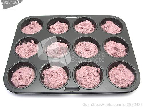 Image of Raspberry muffins in a muffin cake pan before baking