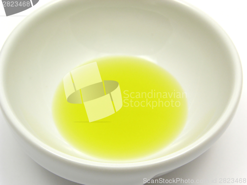 Image of One bowl of chinaware with olive oil in a close-up view