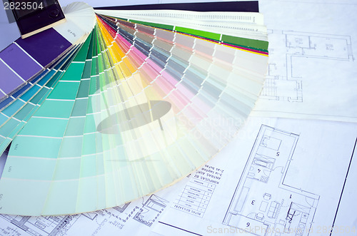 Image of color palette samples lie on house design drawings 