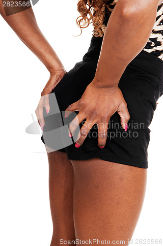 Image of Woman holding her butt.