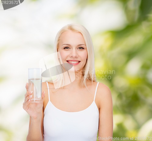 Image of young smiling woman with glass of water