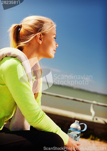 Image of woman resting after doing sports outdoors