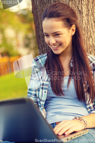 Image of smiling teenager with laptop