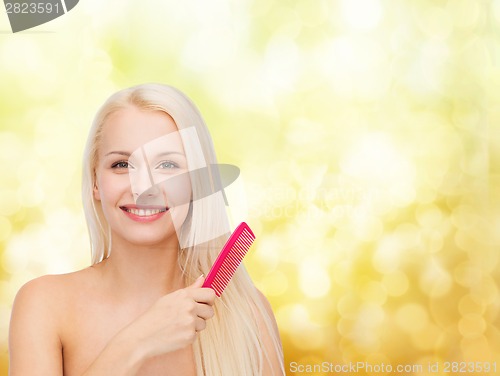 Image of smiling woman with hair brush