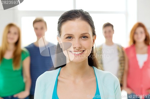 Image of smiling students with teenage girl in front
