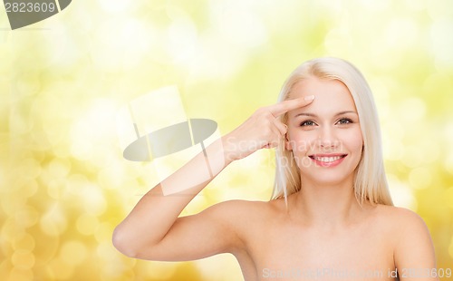 Image of beautiful woman touching her forehead