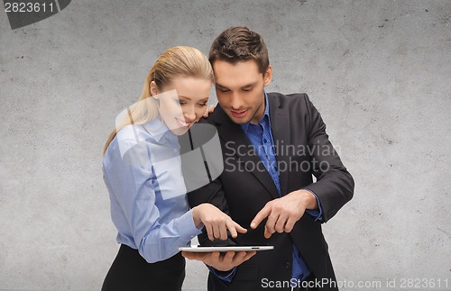 Image of businesswoman and businessman with tablet pc