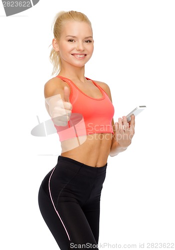 Image of smiling sporty woman with smartphone