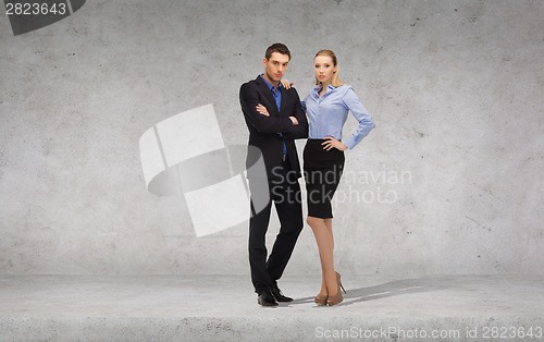 Image of serious businessman and businesswoman