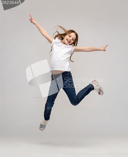 Image of smiling little girl jumping