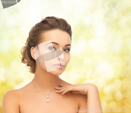 Image of woman wearing shiny diamond pendant