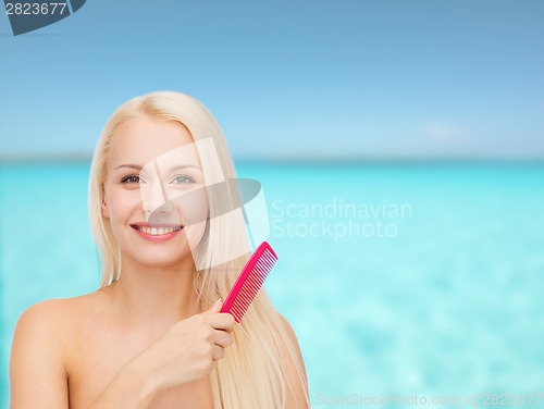 Image of smiling woman with hair brush