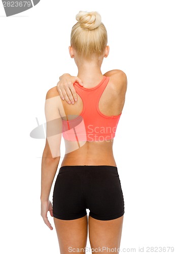 Image of sporty woman touching her shoulder