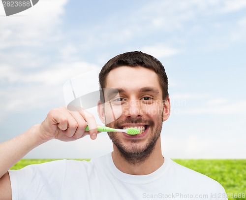 Image of smiling young man with toothbrush