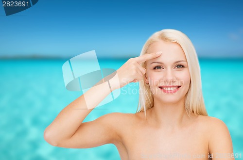Image of beautiful woman touching her forehead