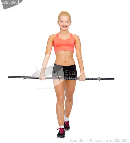 Image of smiling sporty woman exercising with barbell